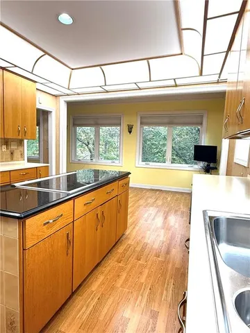 a large white kitchen with a large window