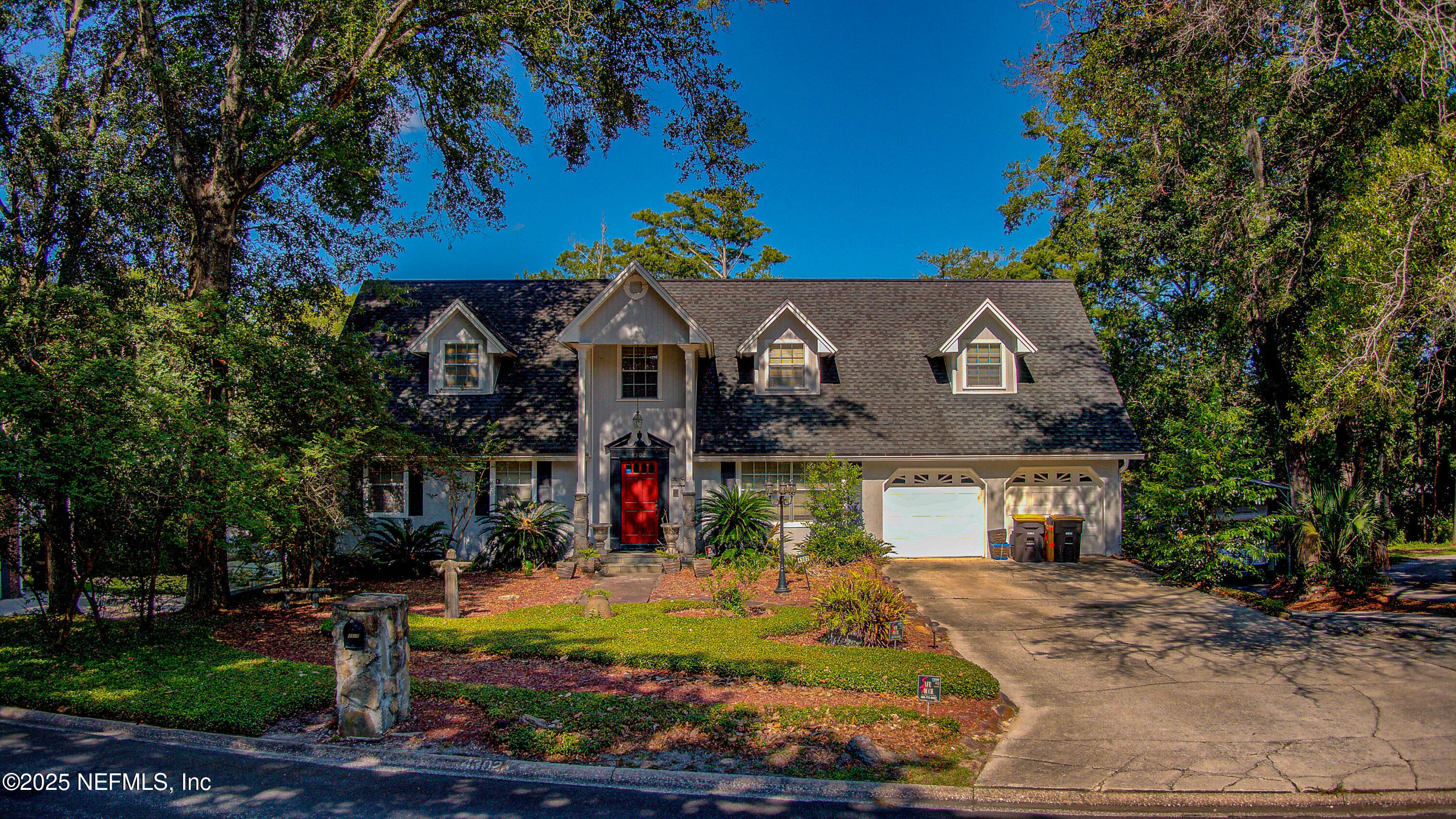 4302 Buck Point Road Jacksonville, FL 32210 - Photo 2 of 74 a front view of a house with a yard and potted plants