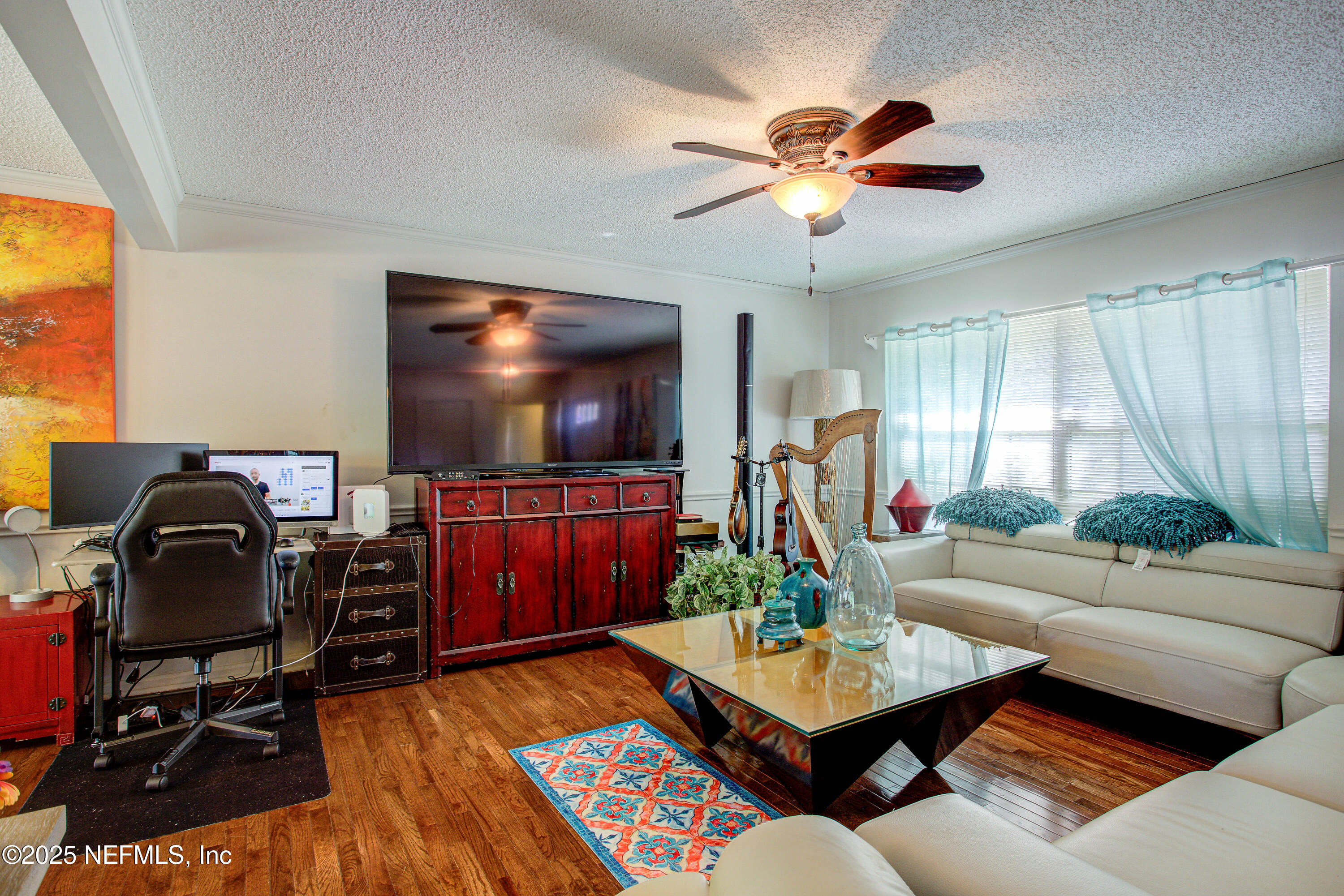 4302 Buck Point Road Jacksonville, FL 32210 - Photo 21 of 74 a living room with furniture and a flat screen tv