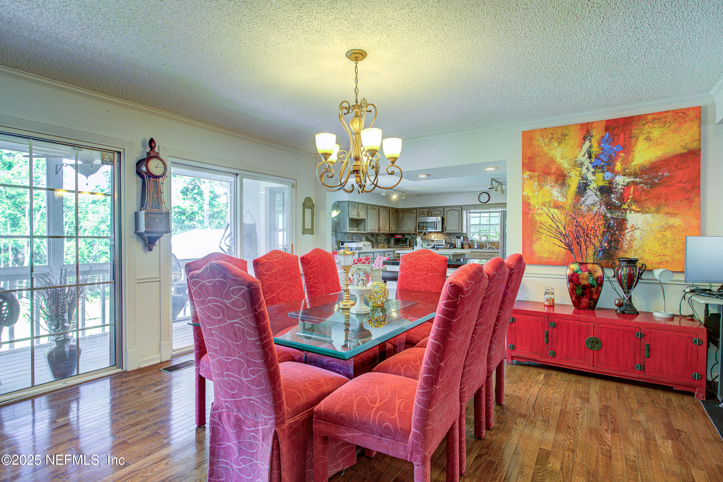4302 Buck Point Road Jacksonville, FL 32210 - Photo 23 of 74 a view of a dining room with furniture a chandelier and large windows