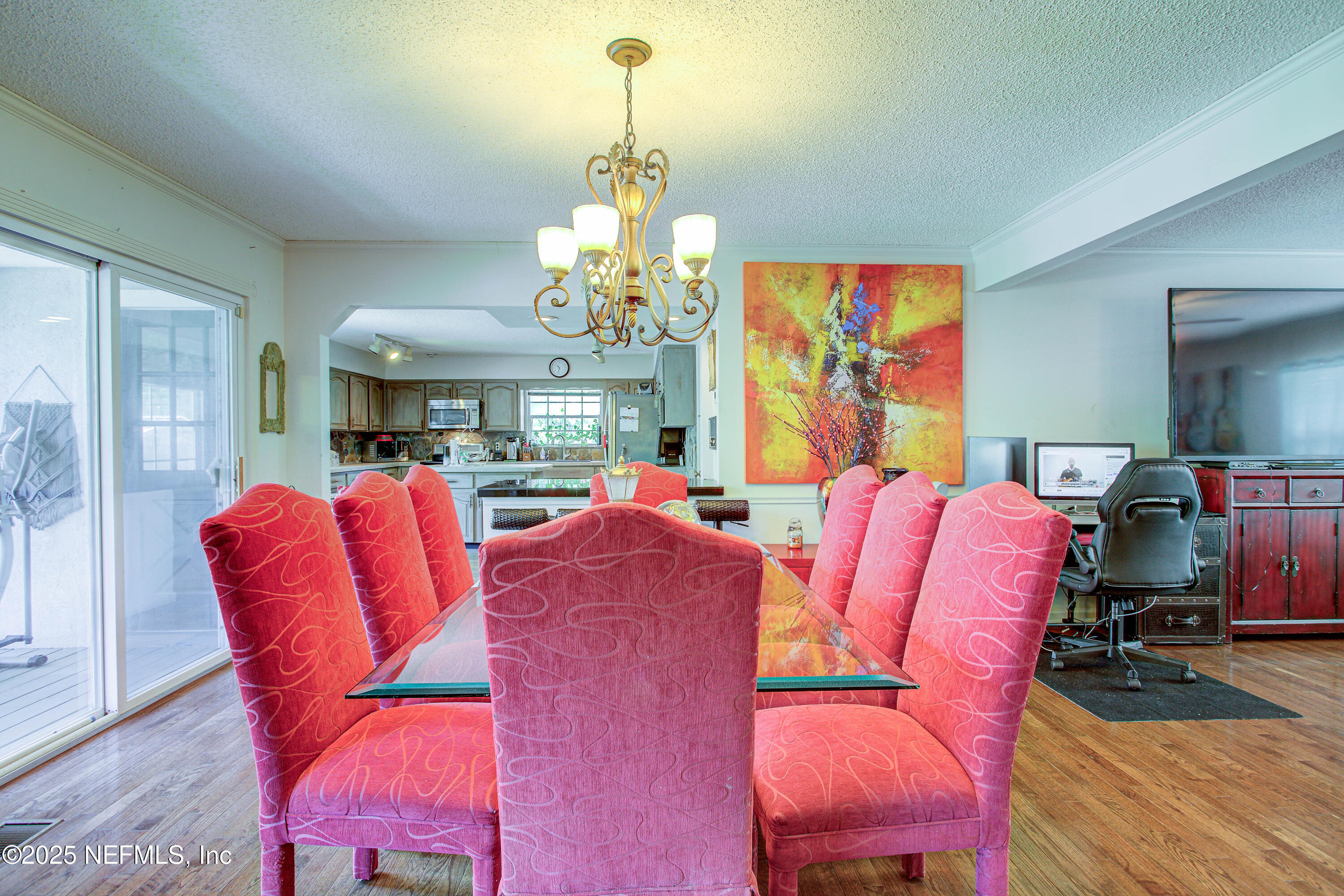 4302 Buck Point Road Jacksonville, FL 32210 - Photo 24 of 74 a living room with furniture a chandelier and a dining table