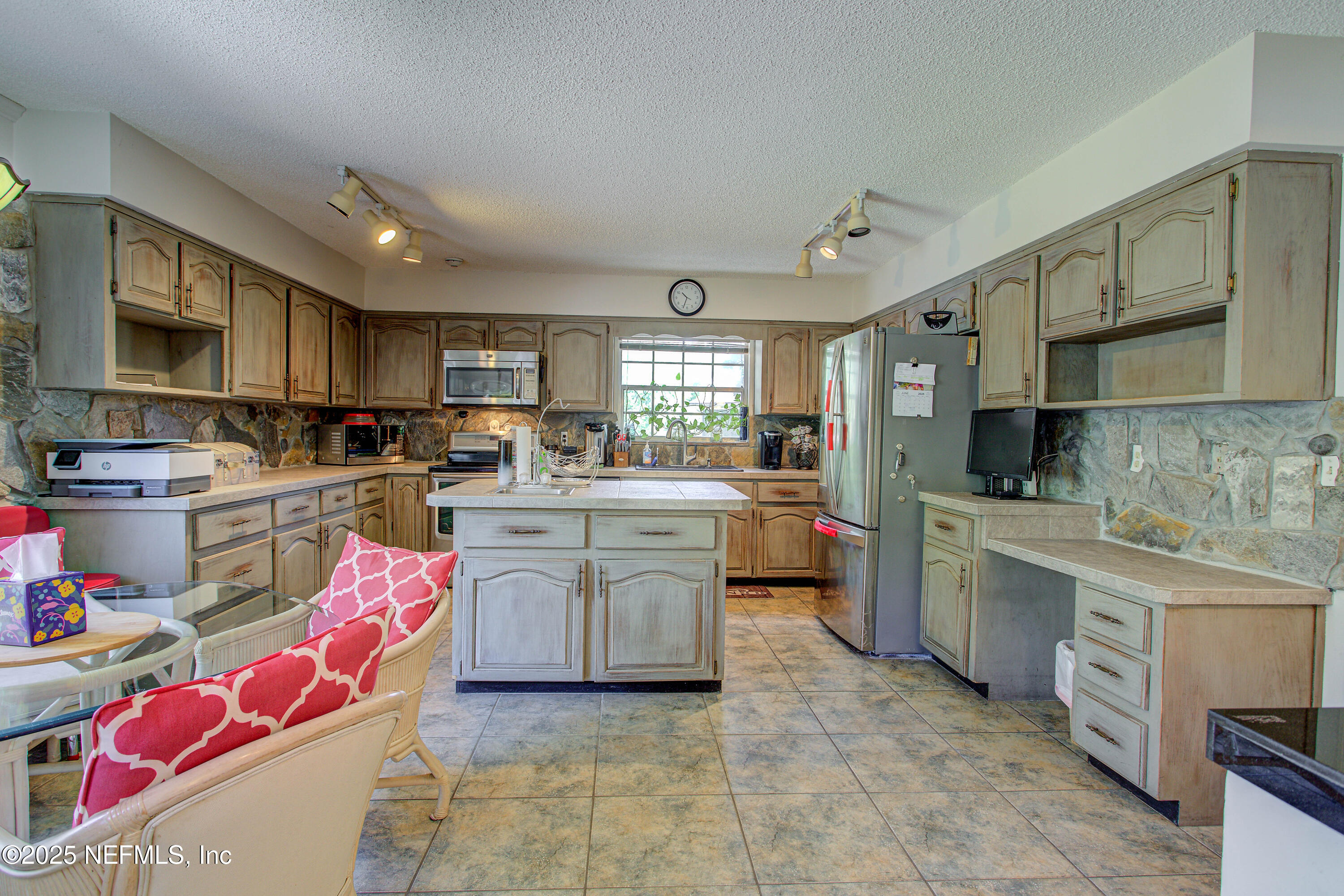 4302 Buck Point Road Jacksonville, FL 32210 - Photo 28 of 74 a kitchen with kitchen island granite countertop lots of white stainless steel appliances