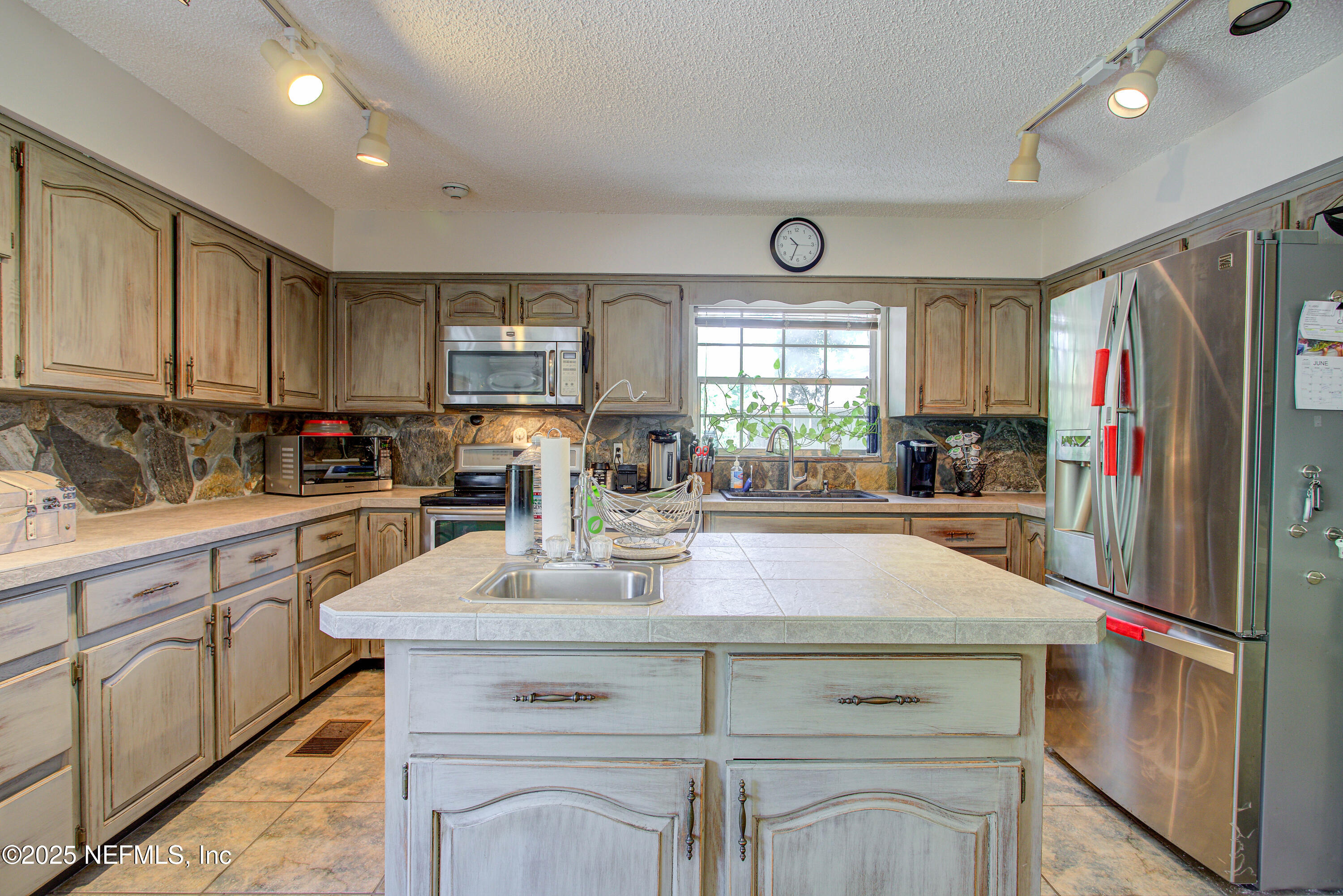 4302 Buck Point Road Jacksonville, FL 32210 - Photo 29 of 74 a kitchen with appliances a sink cabinets and a window