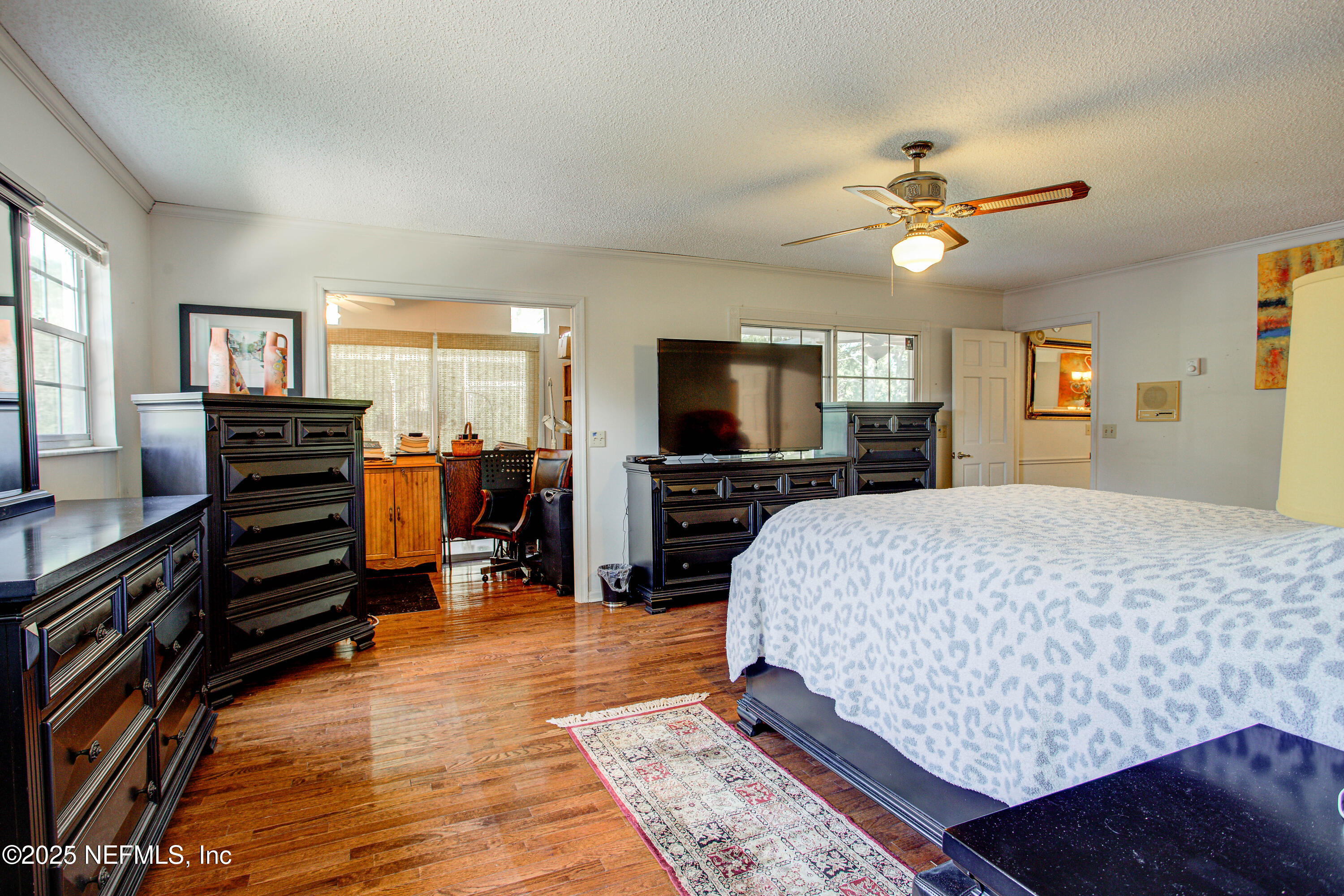 4302 Buck Point Road Jacksonville, FL 32210 - Photo 38 of 74 a bed room with furniture and a flat screen tv