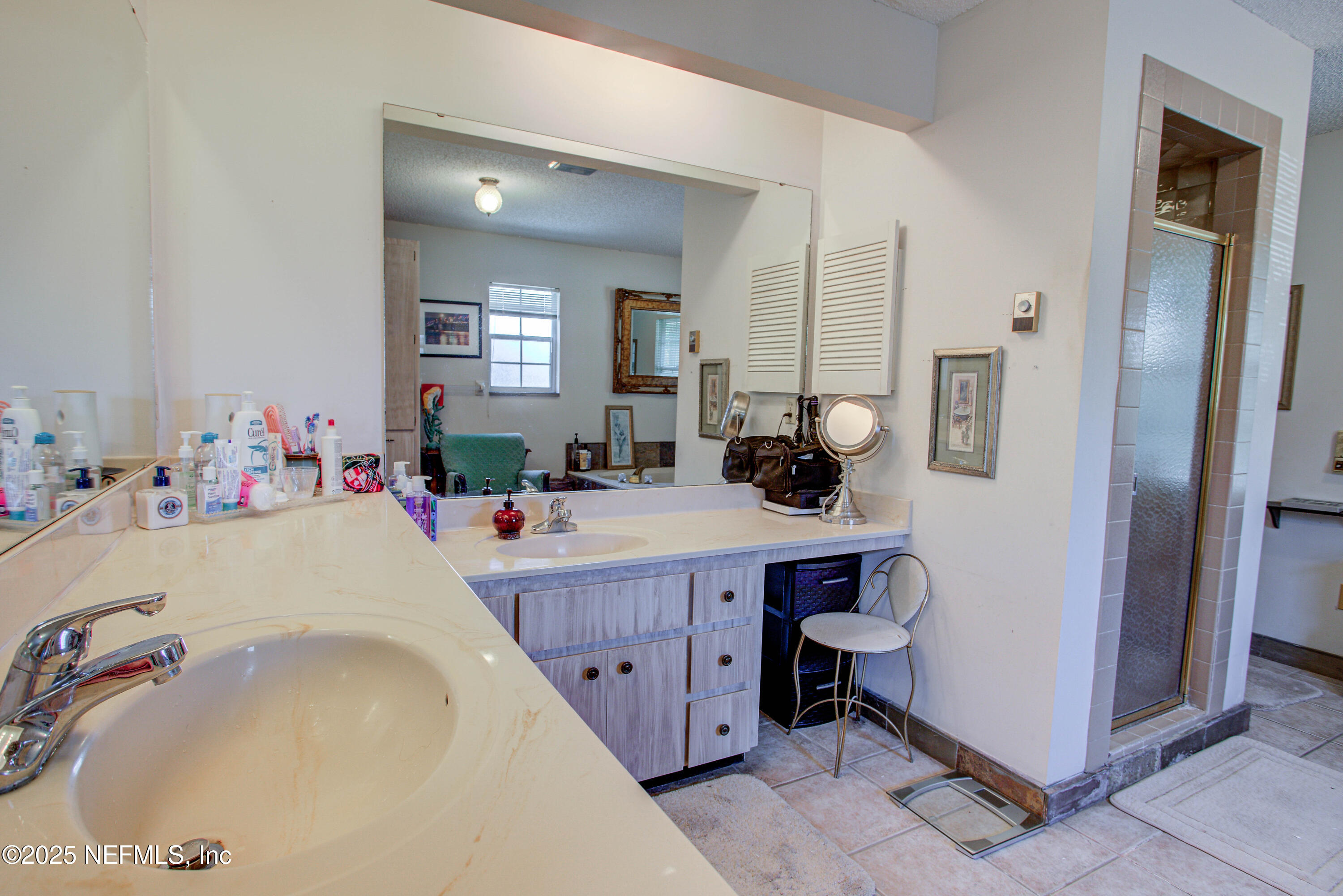 4302 Buck Point Road Jacksonville, FL 32210 - Photo 43 of 74 a bath room with a sink and mirror