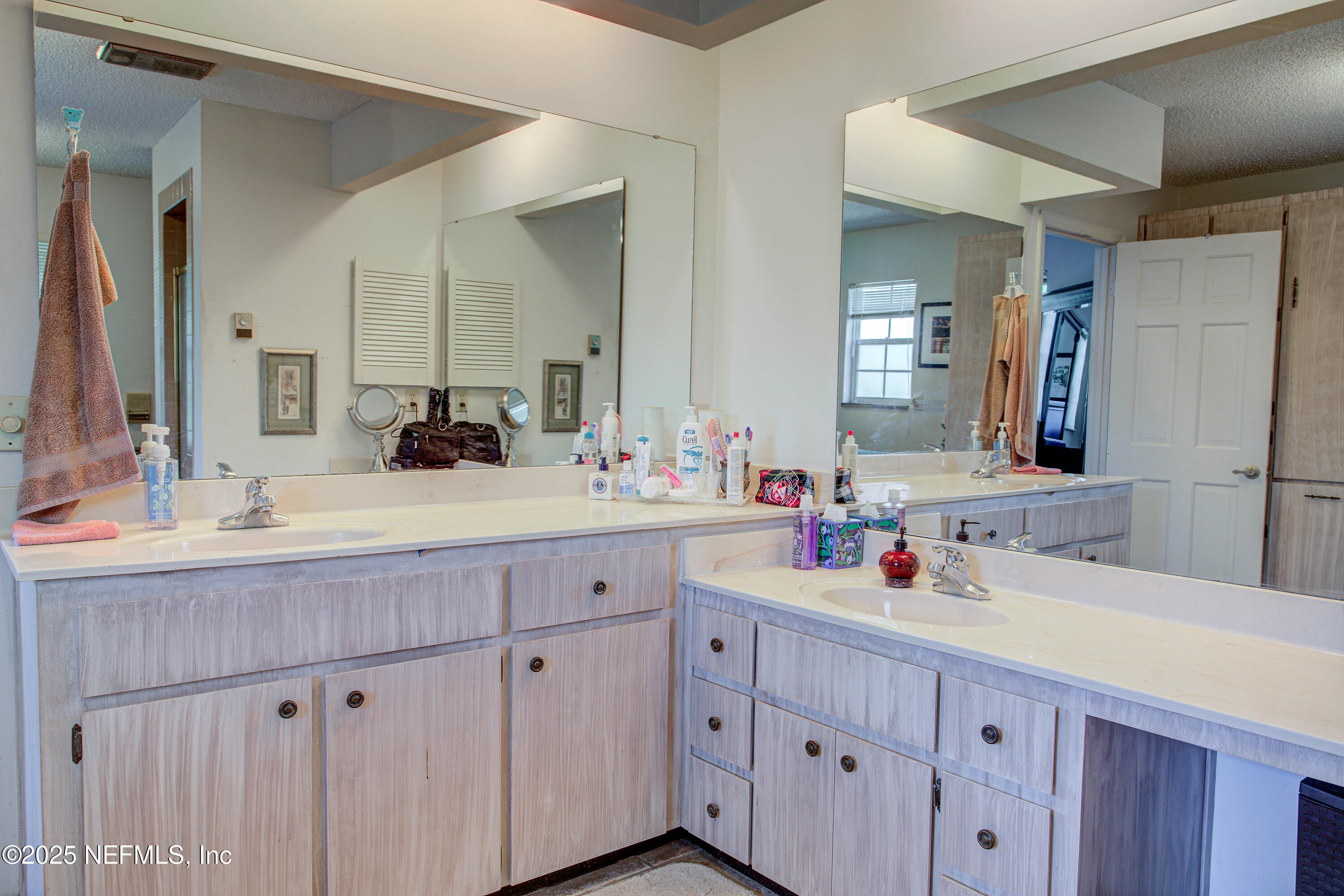 4302 Buck Point Road Jacksonville, FL 32210 - Photo 46 of 74 a bathroom with double sink and a mirror