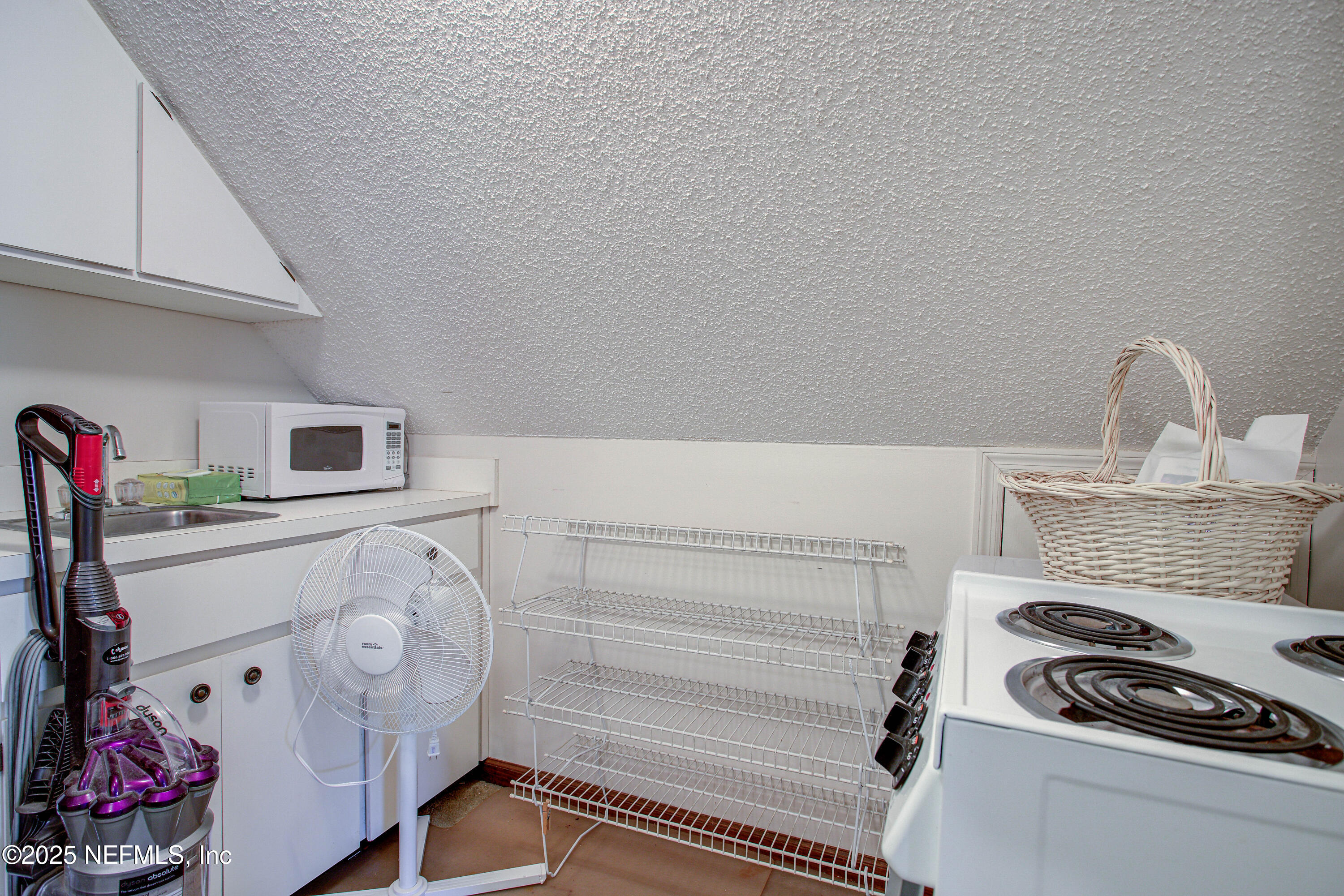 4302 Buck Point Road Jacksonville, FL 32210 - Photo 57 of 74 a kitchen with a stove and white cabinets