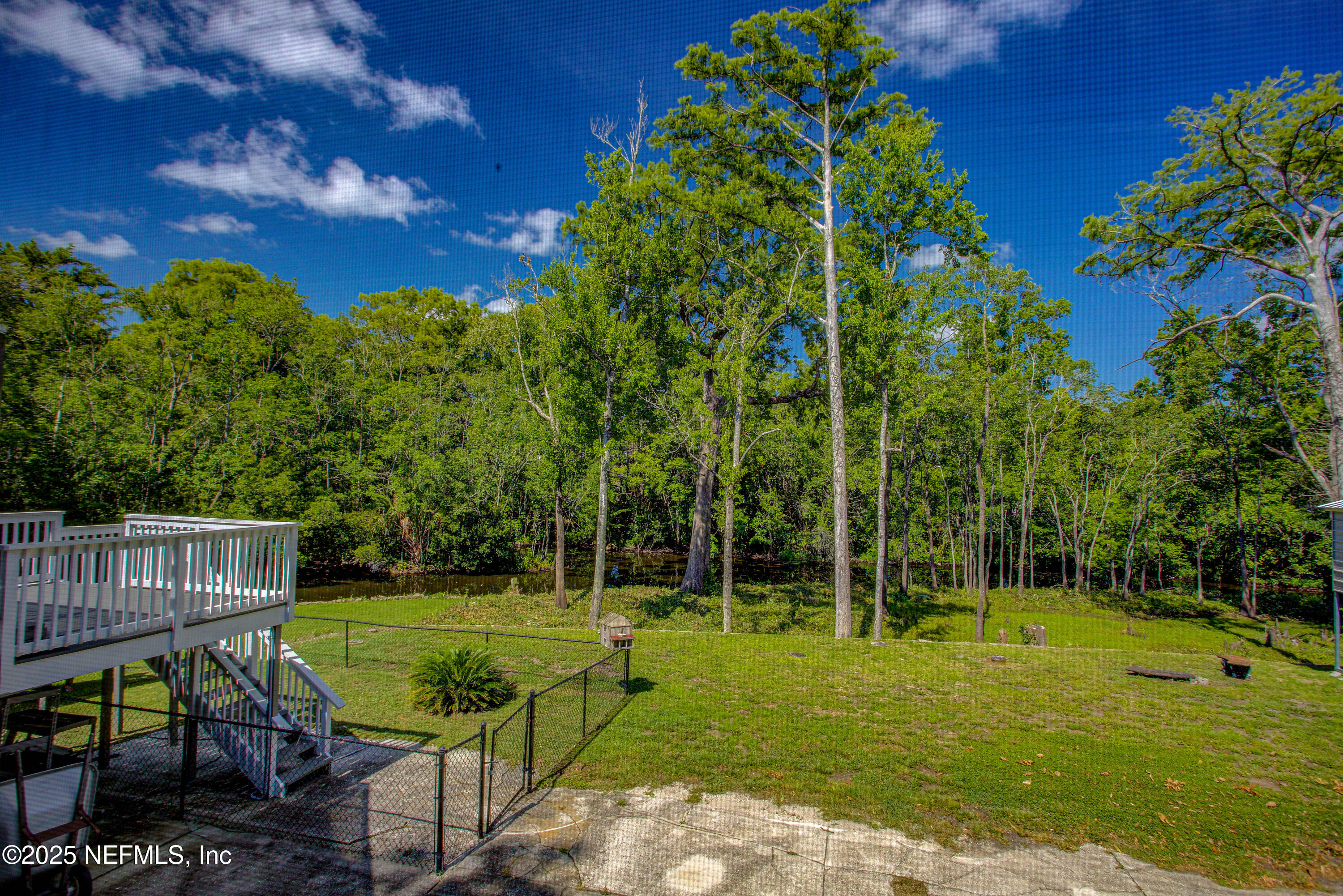4302 Buck Point Road Jacksonville, FL 32210 - Photo 63 of 74 a view of a wooden dinning table and chairs in the garden