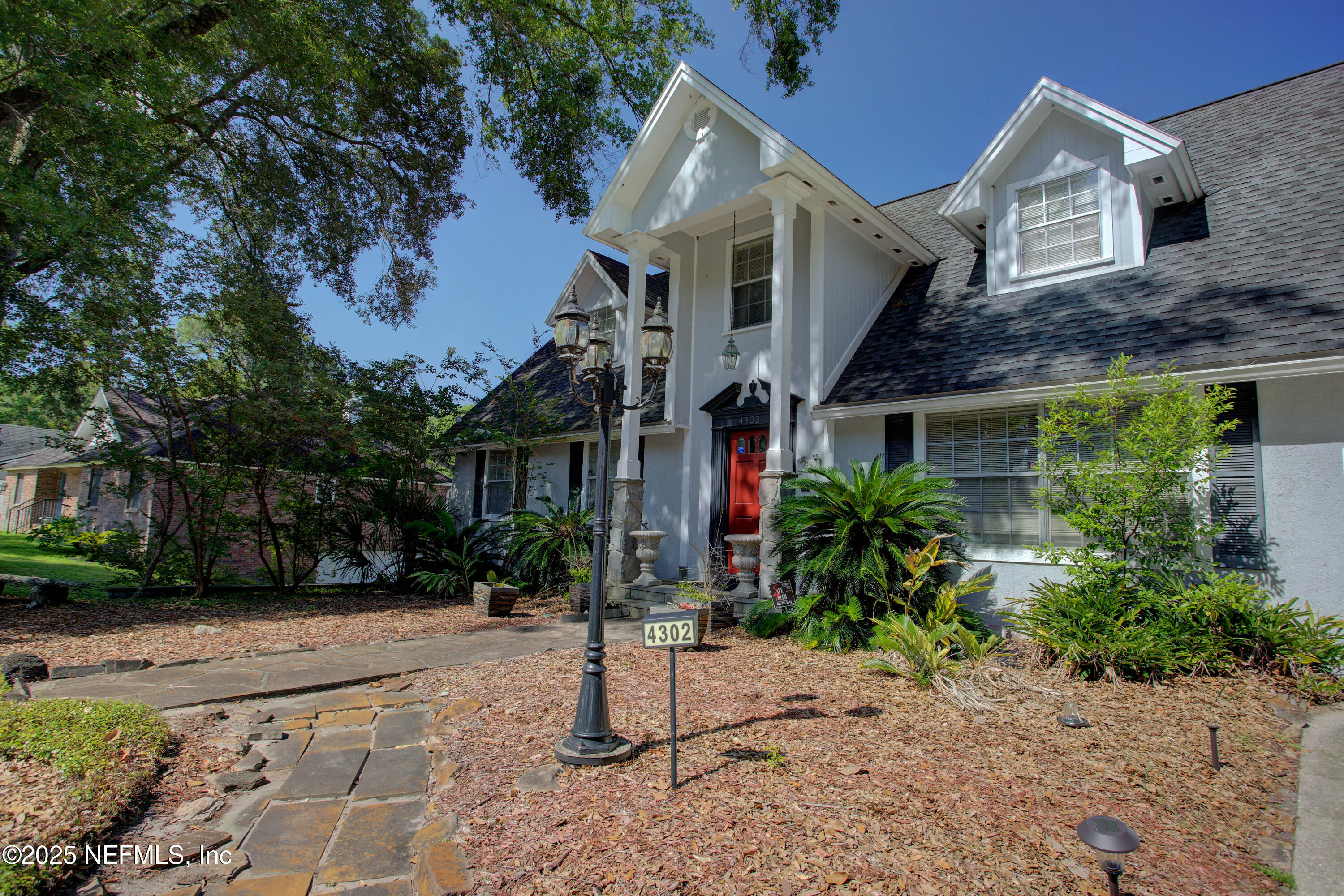 4302 Buck Point Road Jacksonville, FL 32210 - Photo 8 of 74 a front view of a house with a yard