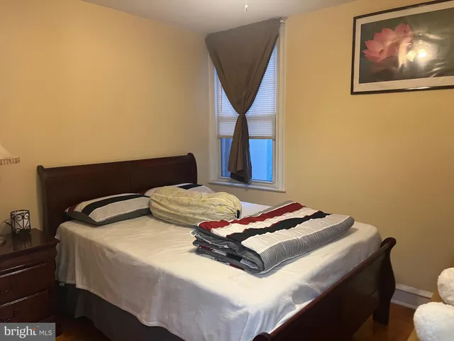 a bedroom with a bed and window