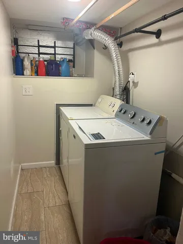 a utility room with a refrigerator and washer