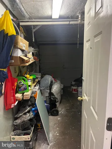 a view of a brick building with floor to windows and outdoor seating