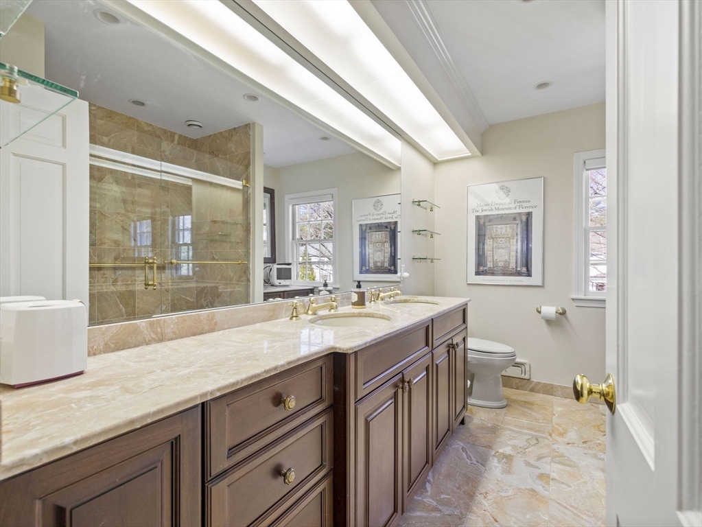 14 Colgate Road Wellesley, MA 02482 - Photo 12 of 19 a spacious bathroom with a granite countertop sink and a mirror