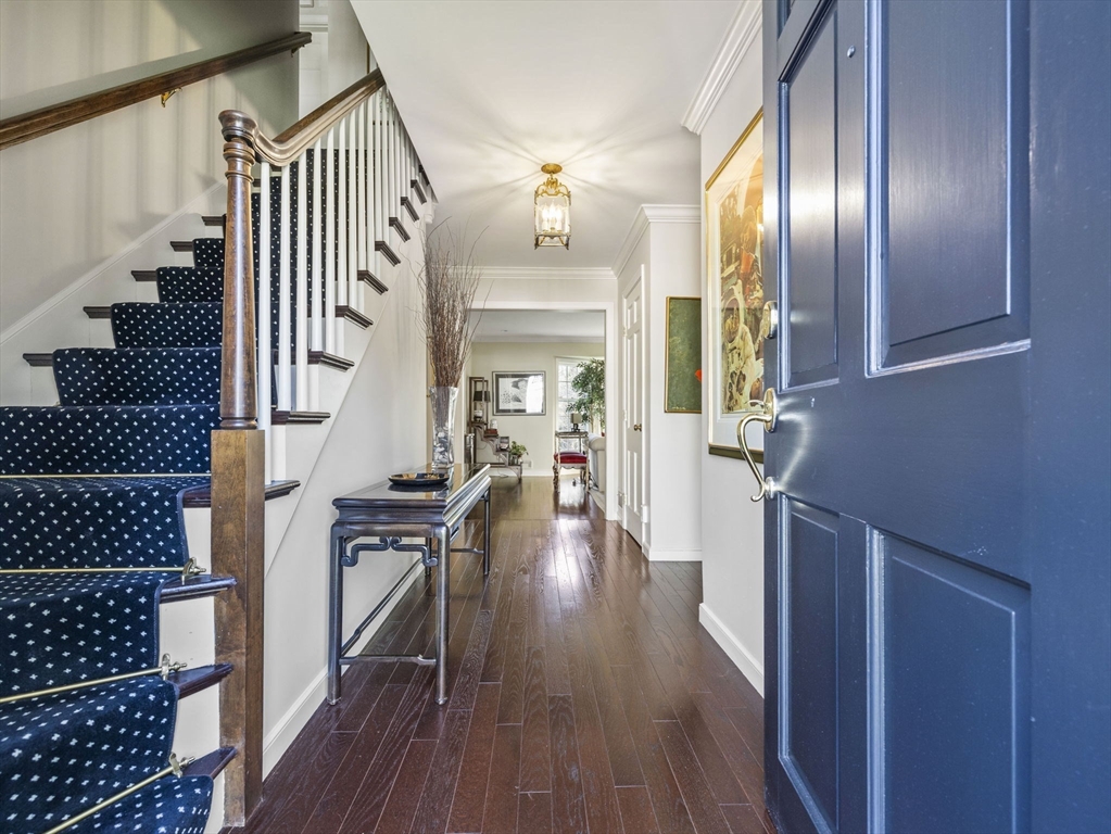 14 Colgate Road Wellesley, MA 02482 - Photo 2 of 19 a view of a hallway with wooden floor and staircase