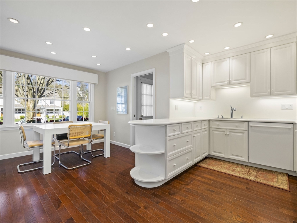 14 Colgate Road Wellesley, MA 02482 - Photo 3 of 19 a kitchen with stainless steel appliances granite countertop a stove a sink and white cabinets with wooden floor next to windows
