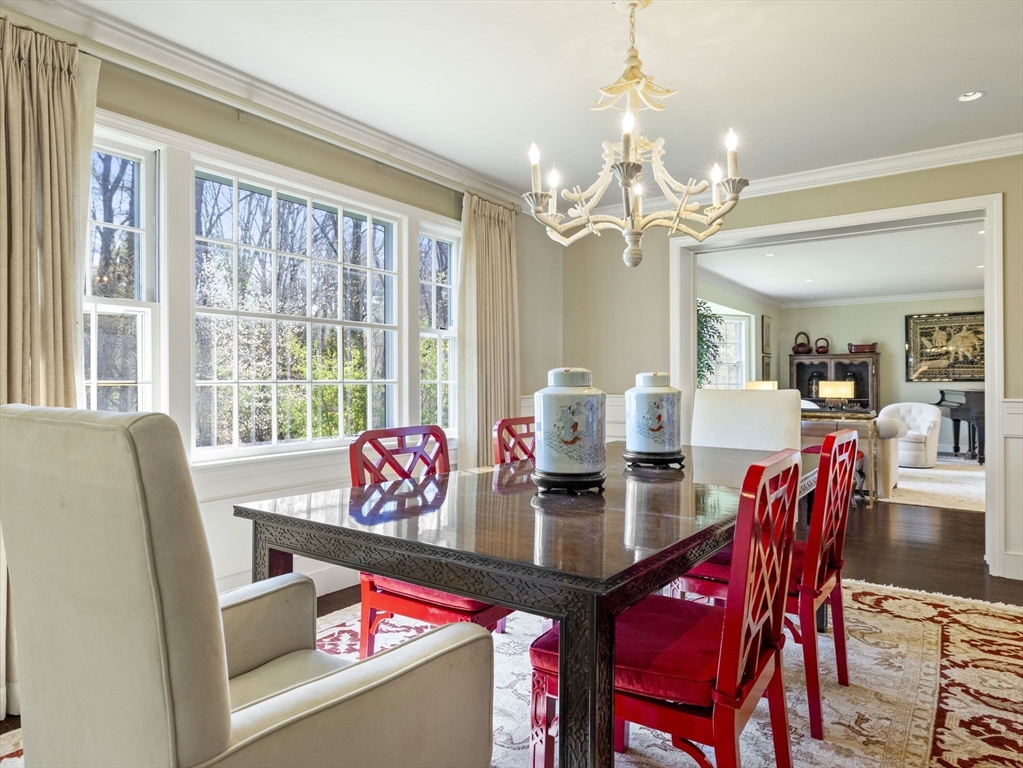 14 Colgate Road Wellesley, MA 02482 - Photo 6 of 19 a view of a dining room with furniture a chandelier and large windows
