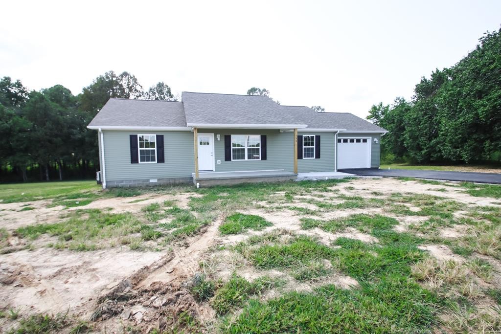a view of a house with yard and a tree