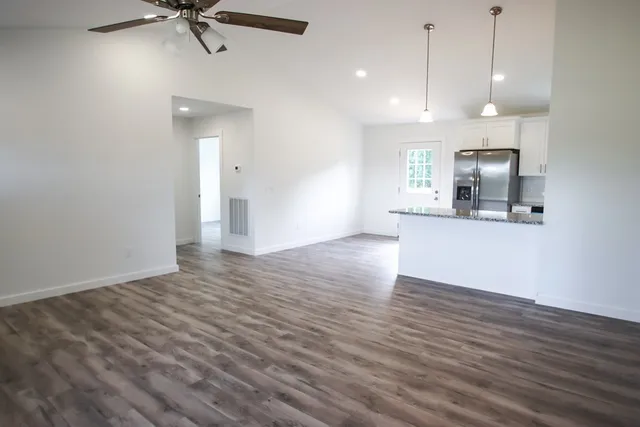 a view of a kitchen with wooden floor and a sink