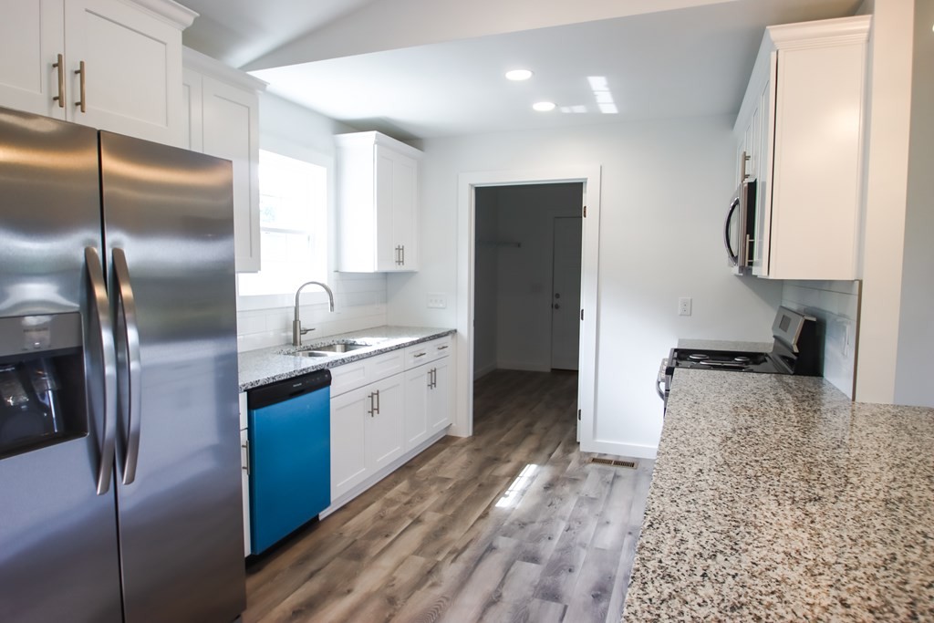 156 Will Thompson Road Sparta, TN 38583 - Photo 7 of 20 a kitchen with granite countertop a refrigerator and a sink