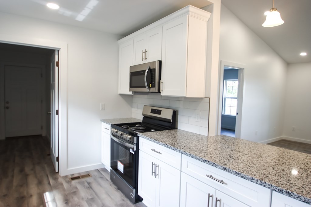 156 Will Thompson Road Sparta, TN 38583 - Photo 8 of 20 a kitchen with granite countertop a sink cabinets and stainless steel appliances