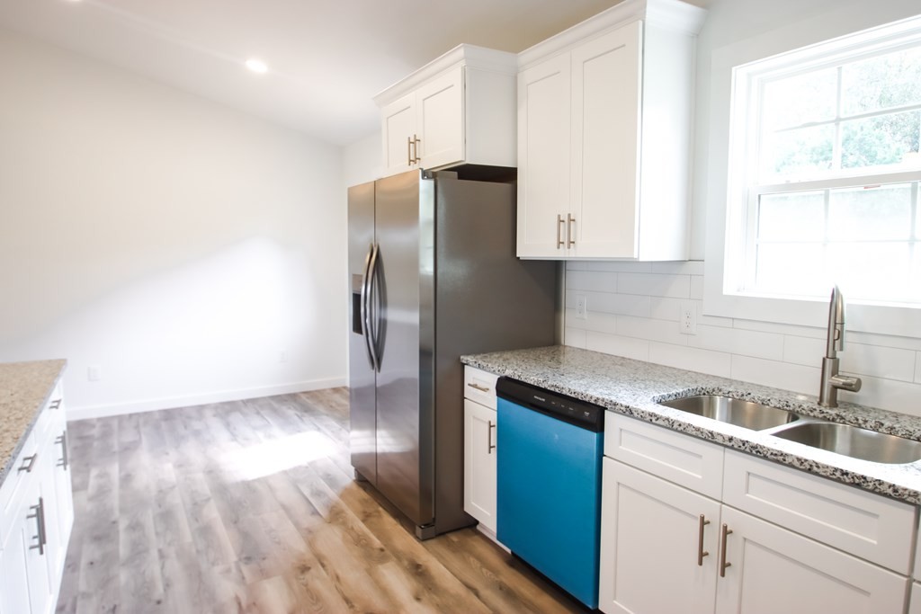 156 Will Thompson Road Sparta, TN 38583 - Photo 9 of 20 a kitchen with a refrigerator sink and cabinets