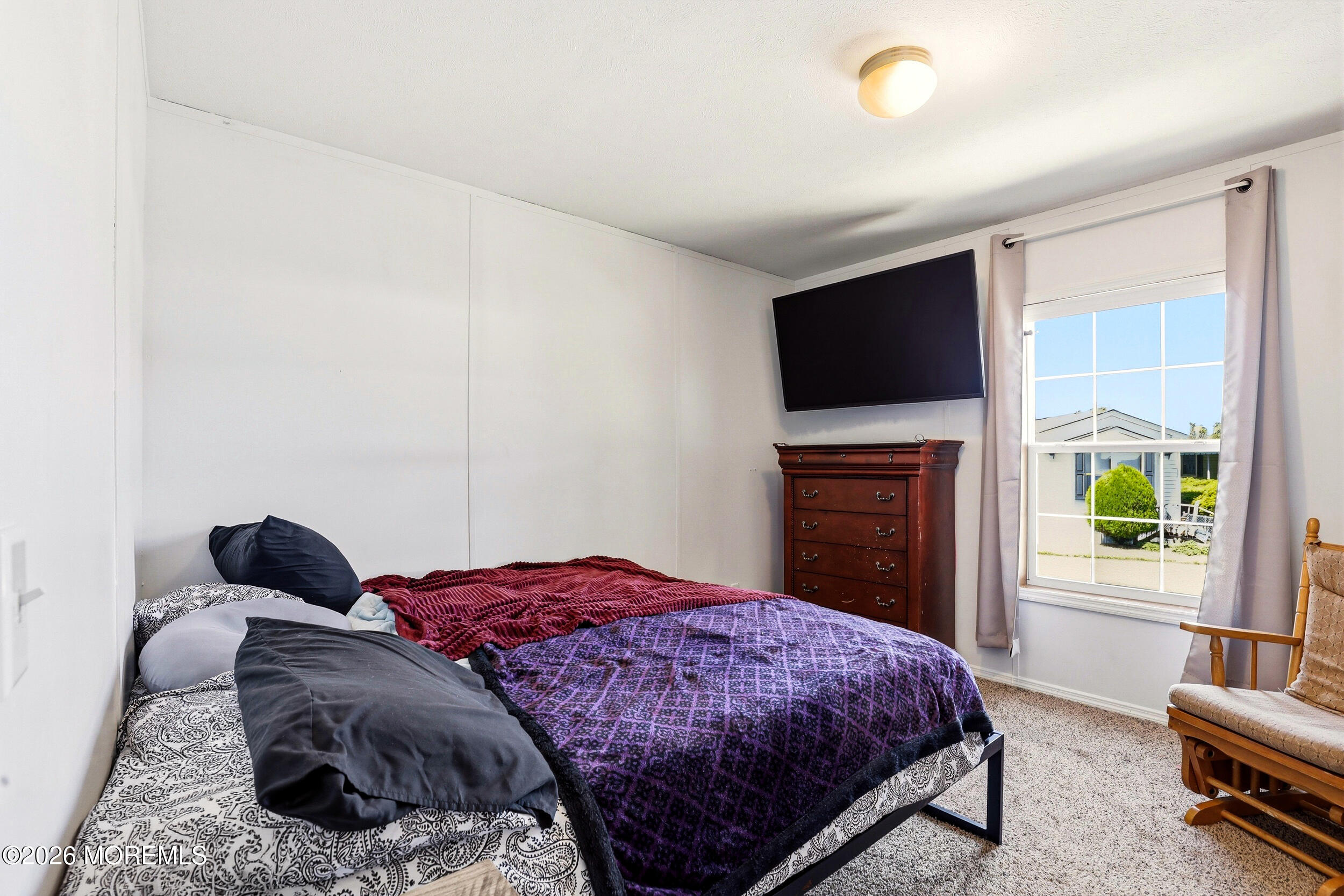 40 Locust Grove Hazlet, NJ 07730 - Photo 12 of 15 a bedroom with a bed and a flat screen tv