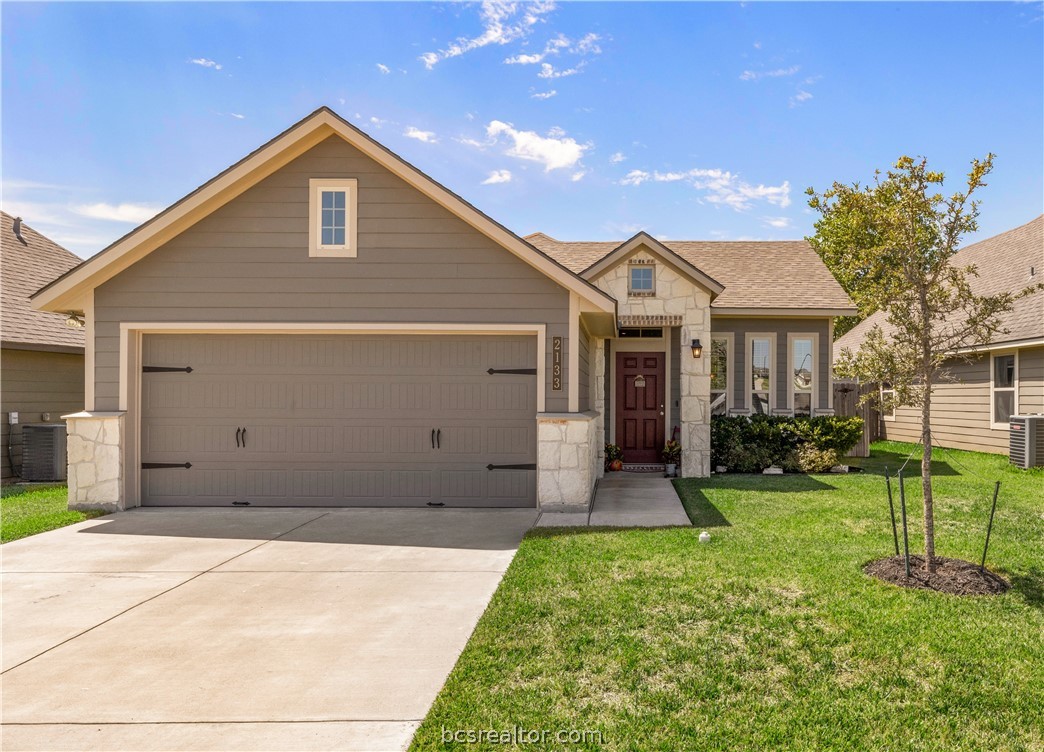 2133 Dumfries Drive Bryan, TX 77807 - Photo 1 of 1 a front view of a house with a yard