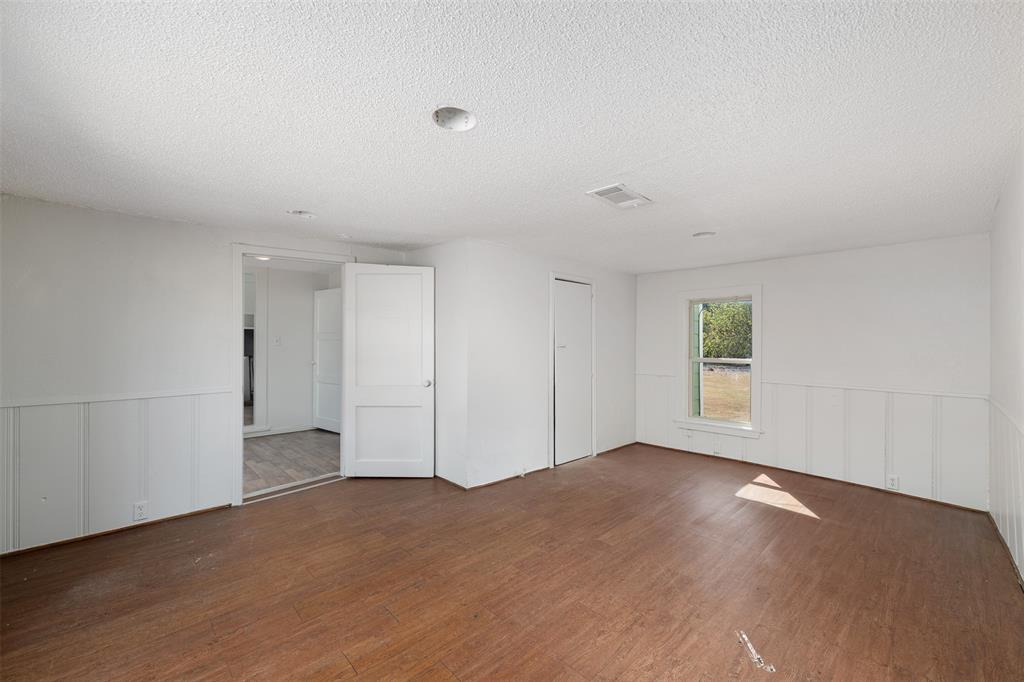102 San Saba Avenue Benbrook, TX 76126 - Photo 11 of 25 an empty room with windows and closet