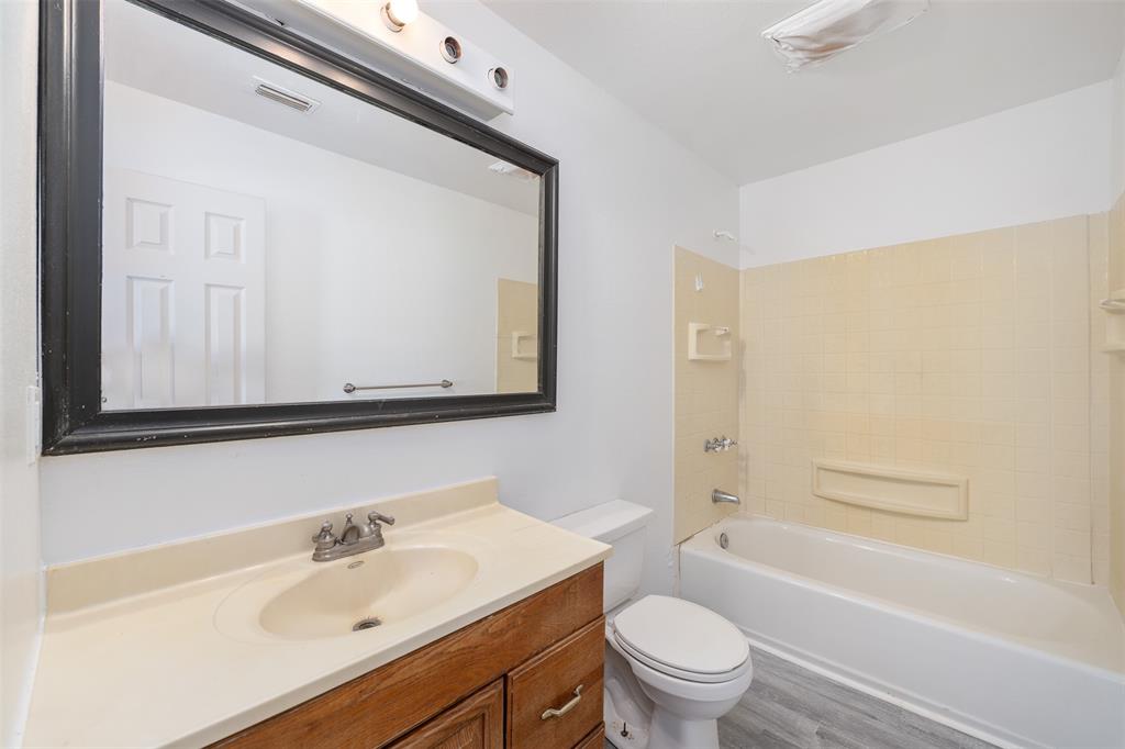 102 San Saba Avenue Benbrook, TX 76126 - Photo 14 of 25 a bathroom with a sink a toilet and a bathtub