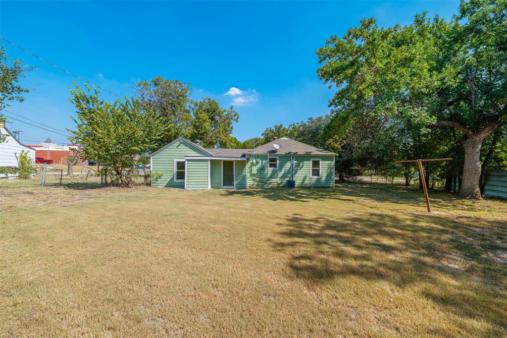 102 San Saba Avenue Benbrook, TX 76126 - Photo 19 of 25 a front view of a house with a yard