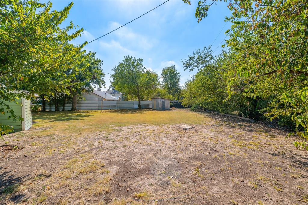 102 San Saba Avenue Benbrook, TX 76126 - Photo 22 of 25 a view of a yard with a tree