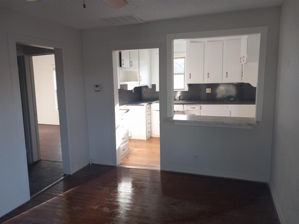 102 San Saba Avenue Benbrook, TX 76126 - Photo 6 of 25 a view of a refrigerator a window and wooden floor