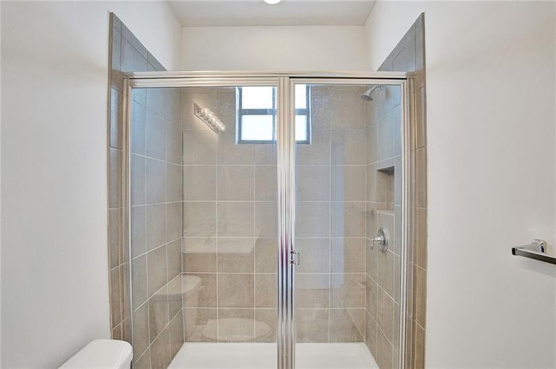 3313 Northwest 11th Avenue Pompano Beach, FL 33064 - Photo 17 of 20 a bathroom with a glass shower door