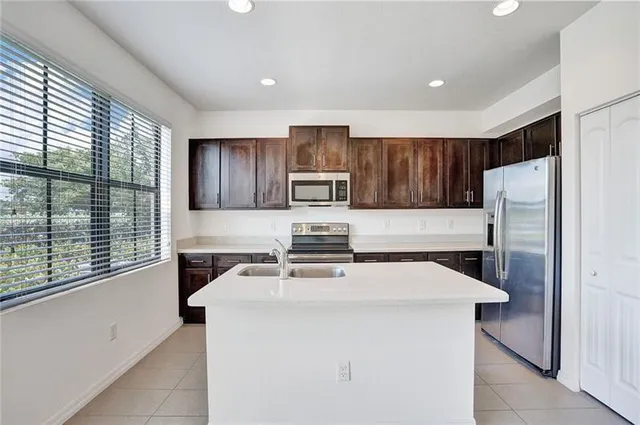 a kitchen with a stove a refrigerator and a sink