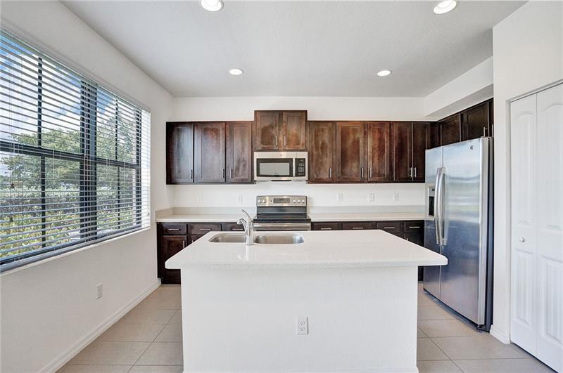 3313 Northwest 11th Avenue Pompano Beach, FL 33064 - Photo 4 of 20 a kitchen with a stove a refrigerator and a sink