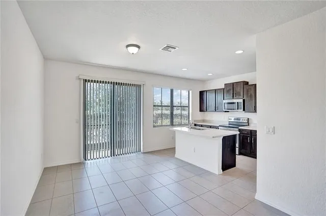 a view of staircase with white walls and white door