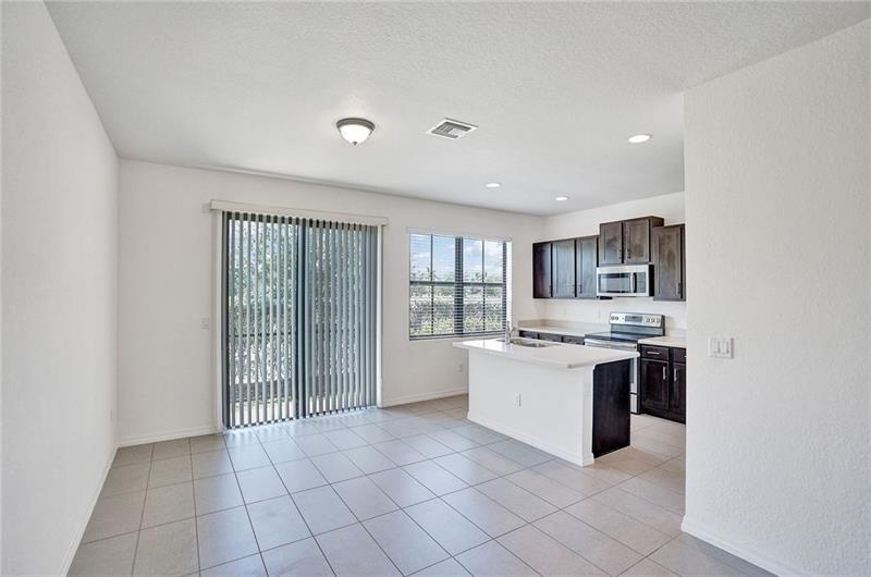 3313 Northwest 11th Avenue Pompano Beach, FL 33064 - Photo 9 of 20 a large kitchen with a stove top oven and cabinets