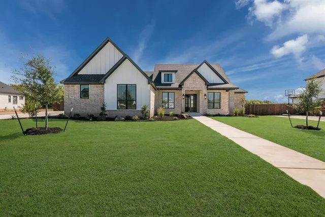 a front view of house with yard and green space