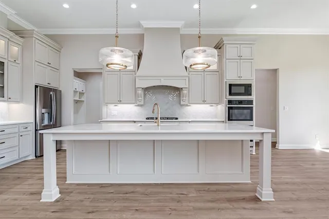 a very nice looking kitchen with granite countertop a stove and a sink