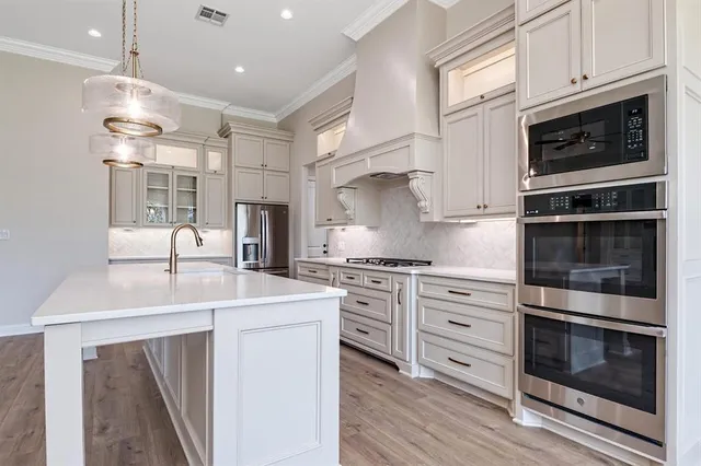 a view of a kitchen with granite countertop stainless steel appliances and wooden floor