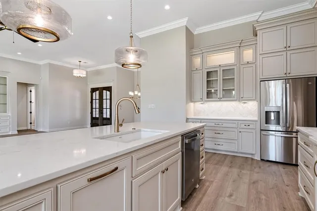 a kitchen with stainless steel appliances granite countertop a stove and white cabinets
