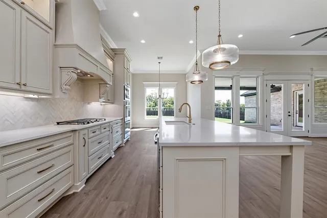 a kitchen with granite countertop a stove and a refrigerator