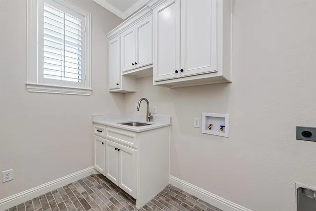 a view of a kitchen with wooden floor and electronic appliances
