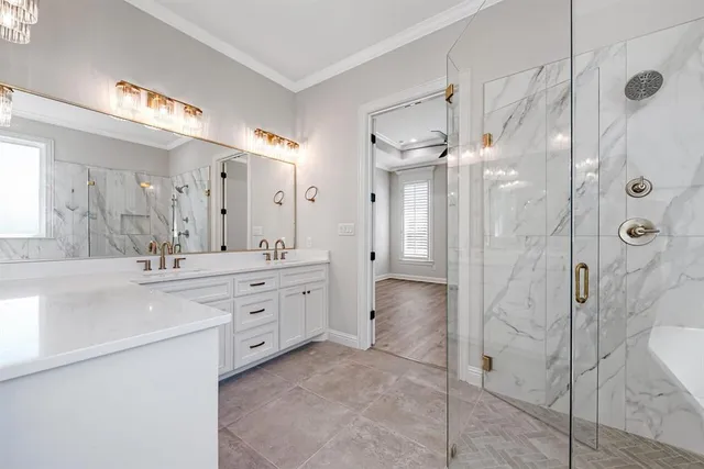 a spacious bathroom with a double vanity sink mirror and bathtub