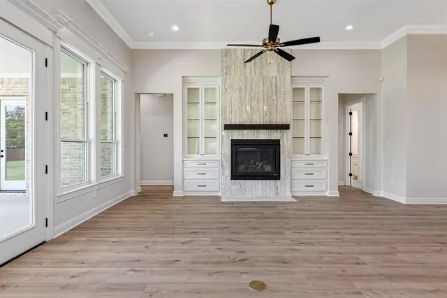 a view of an empty room with a fireplace and a window
