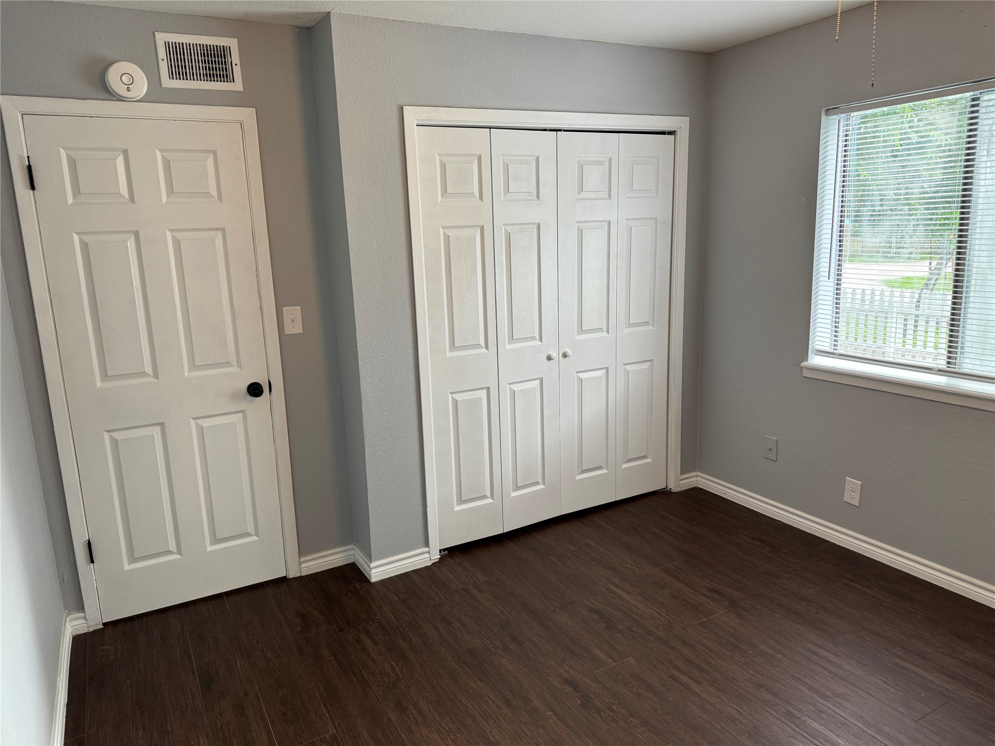 1221 Houston Street, Unit 1 Rosenberg, TX 77471 - Photo 5 of 11 an empty room with wooden floor and closet area
