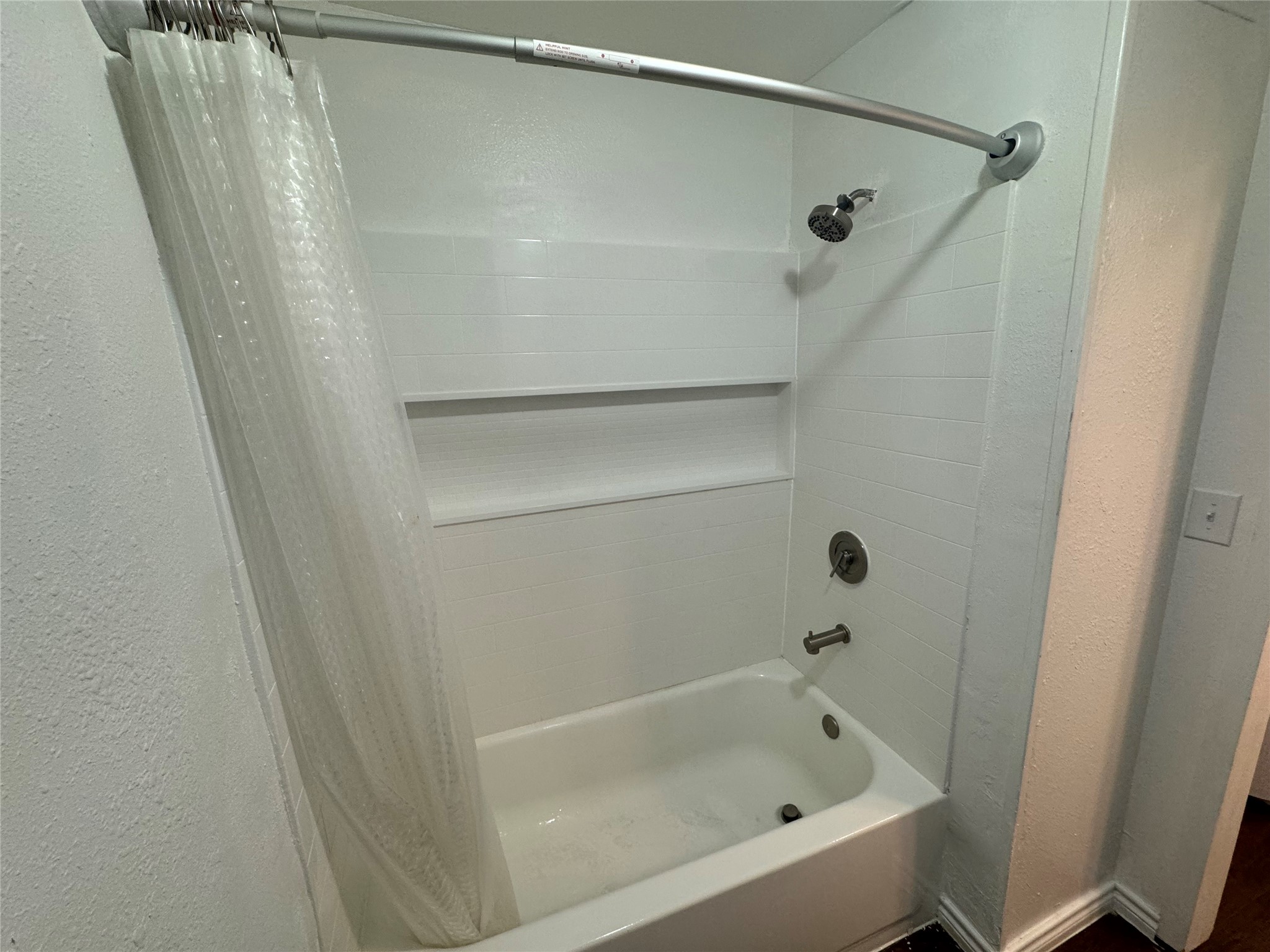 1221 Houston Street, Unit 1 Rosenberg, TX 77471 - Photo 10 of 11 a bathroom with a bathtub