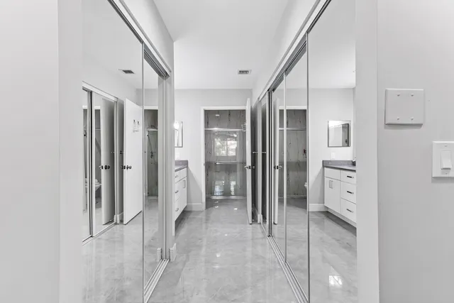 a view of a hallway with wooden shelves