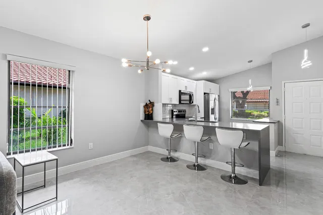 a view of kitchen with refrigerator and window