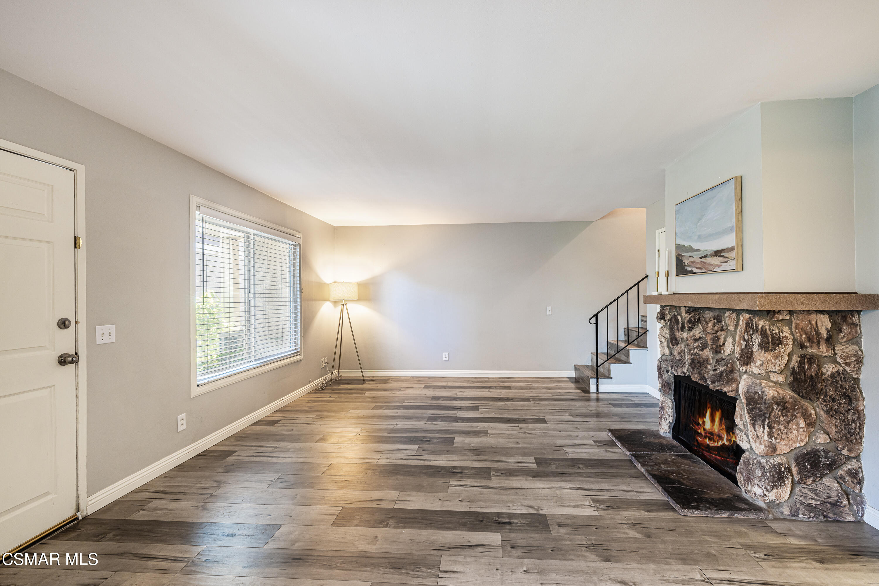 568 Spring Road, Unit 74 Moorpark, CA 93021 - Photo 3 of 28 a view of empty room with wooden floor and fireplace